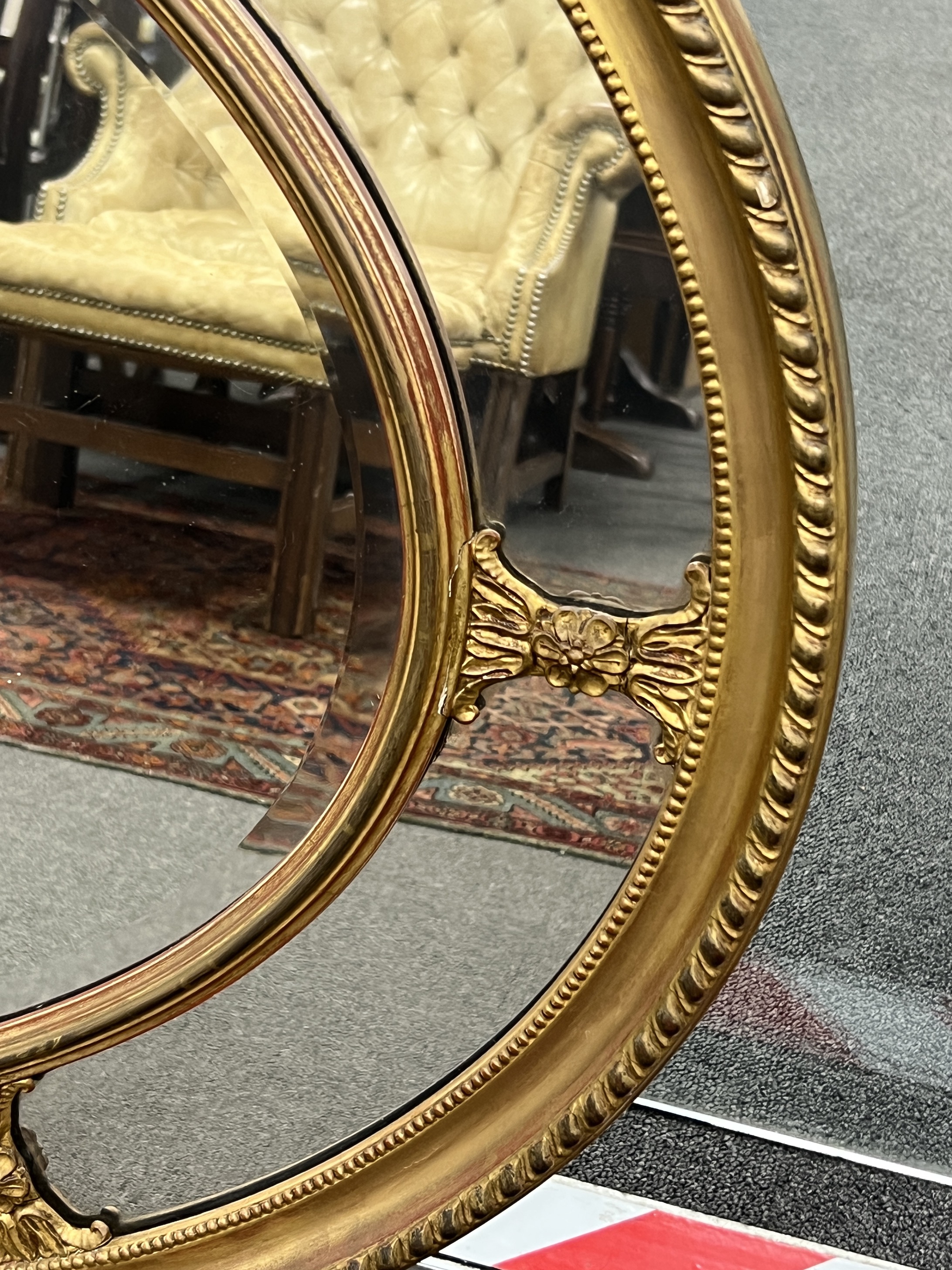 An oval giltwood and composition marginal plate wall mirror, width 113cm, height 83cm